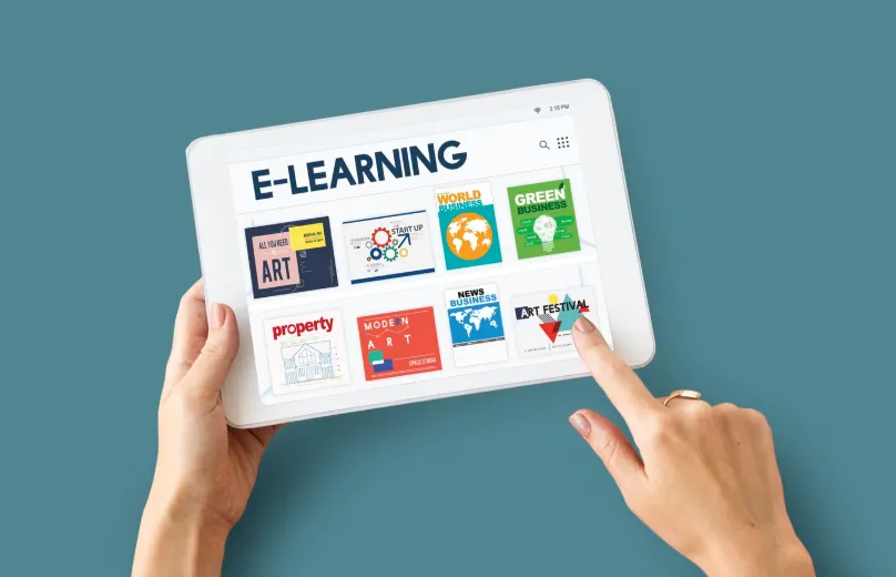 Hands using an e-learning dashboard on a tablet.