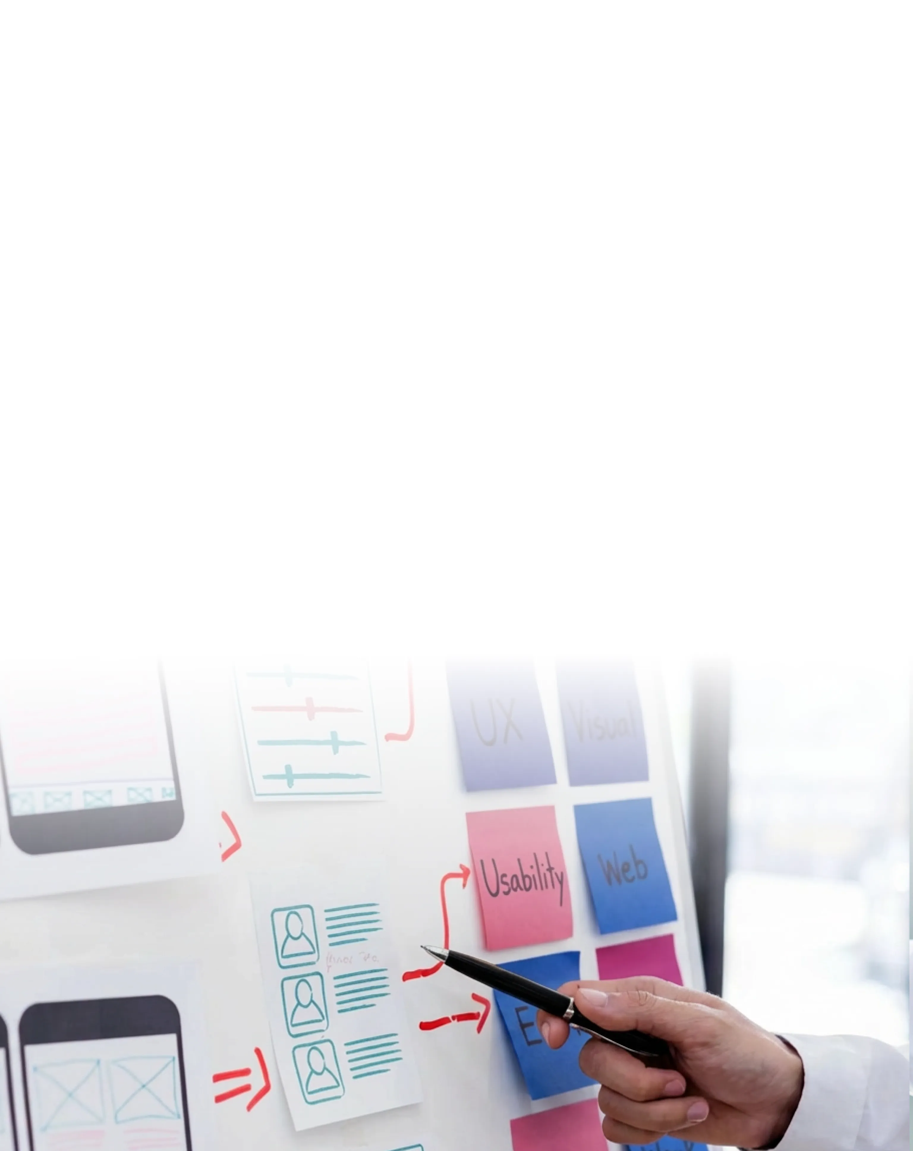 Hands arranging colorful sticky notes on a whiteboard for UX planning